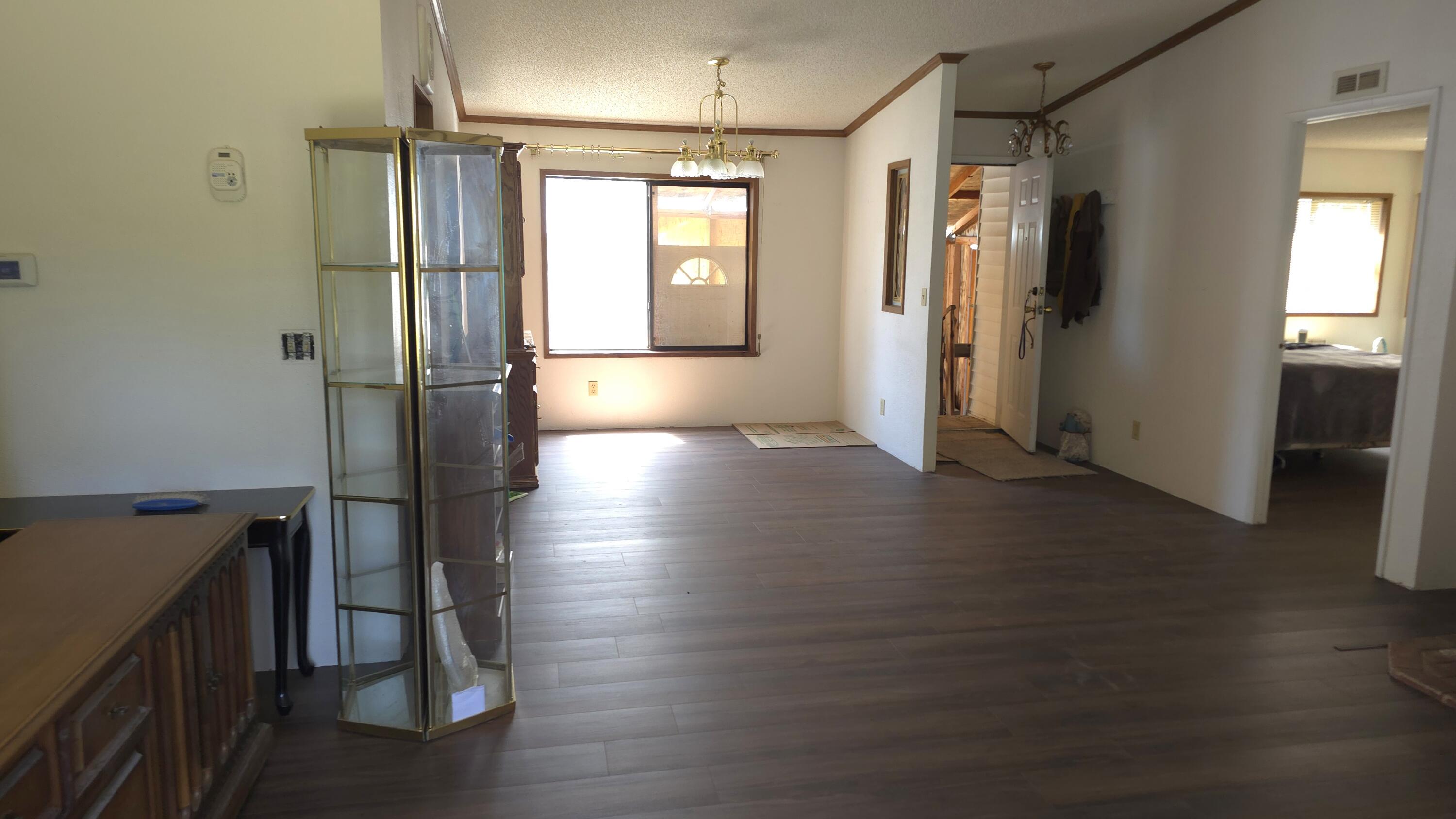 16523 Sprague Loop La Pine, OR 97739 - Photo 6 of 16 a view of hallway with wooden floor and stairs