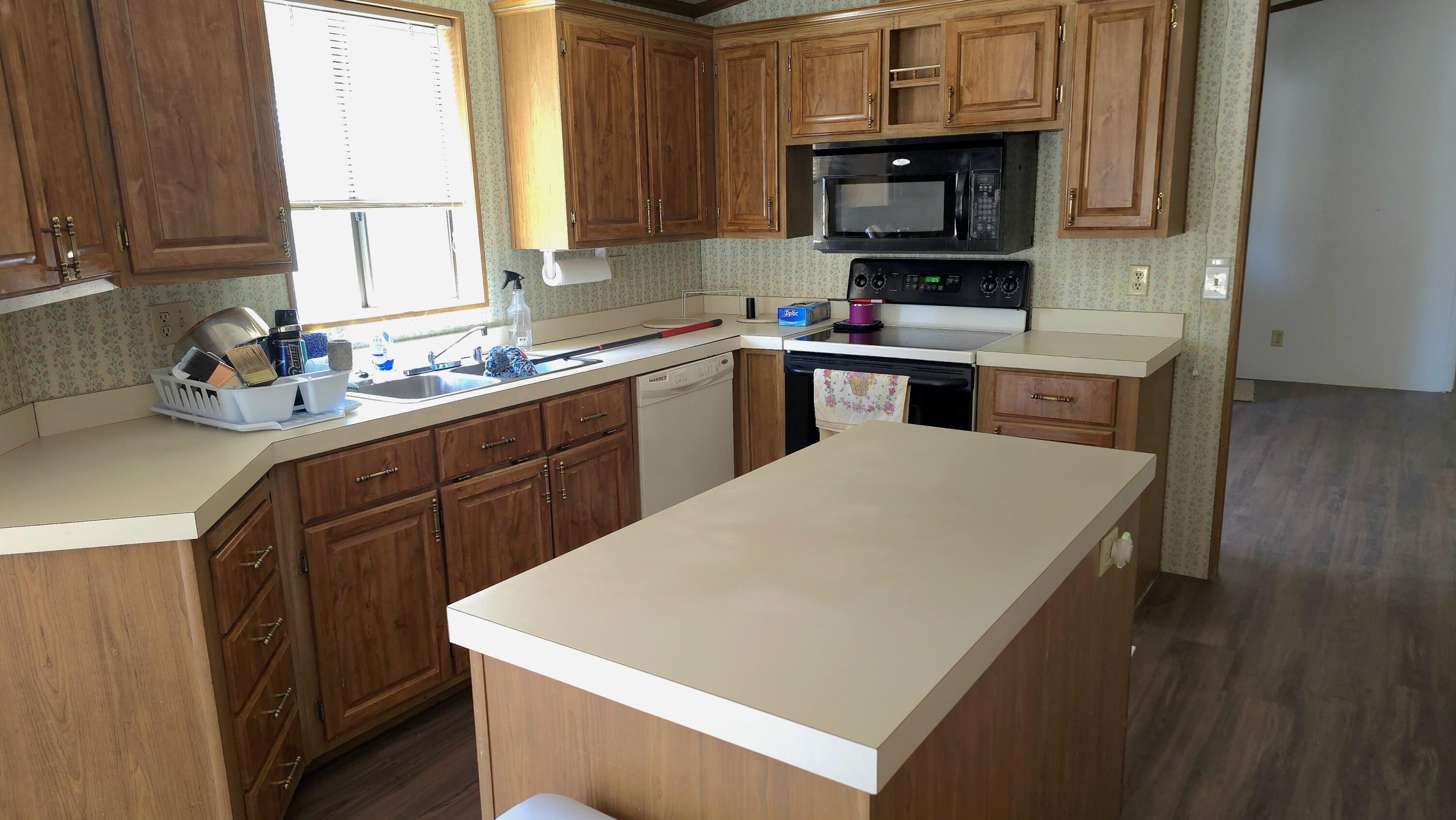 16523 Sprague Loop La Pine, OR 97739 - Photo 8 of 16 a kitchen with a stove a sink and a microwave