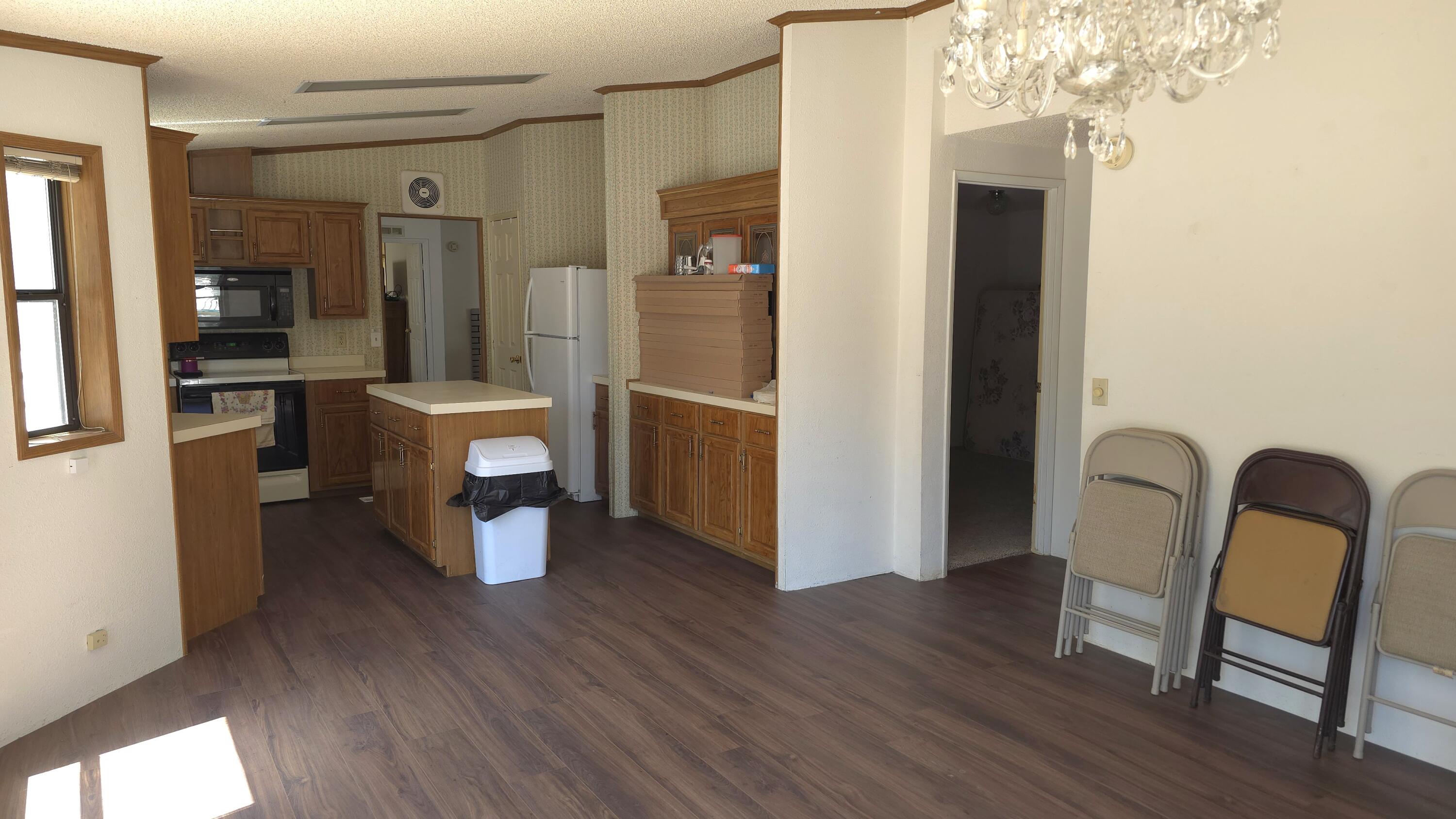 16523 Sprague Loop La Pine, OR 97739 - Photo 10 of 16 a view of a hallway with wooden floor and dining room