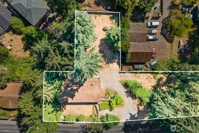 an aerial view of a house with a yard and lake view