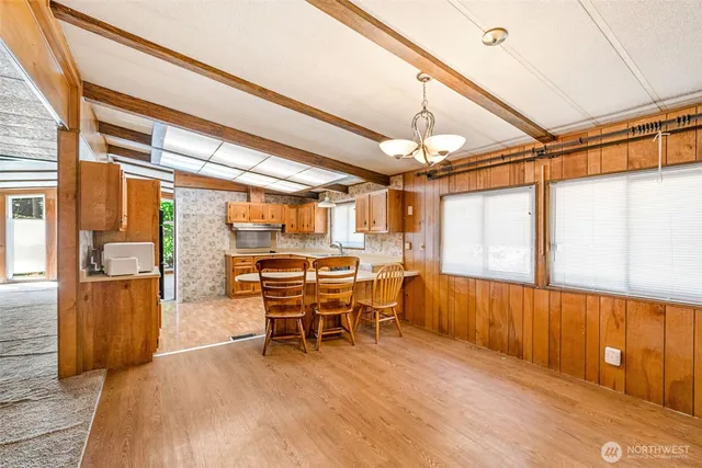 a dining room with furniture and wooden floor