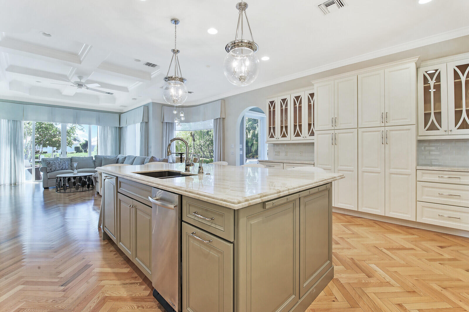 3370 Bridgegate Drive Jupiter, FL 33477 - Photo 13 of 55 a kitchen with kitchen island granite countertop a sink cabinets and wooden floor