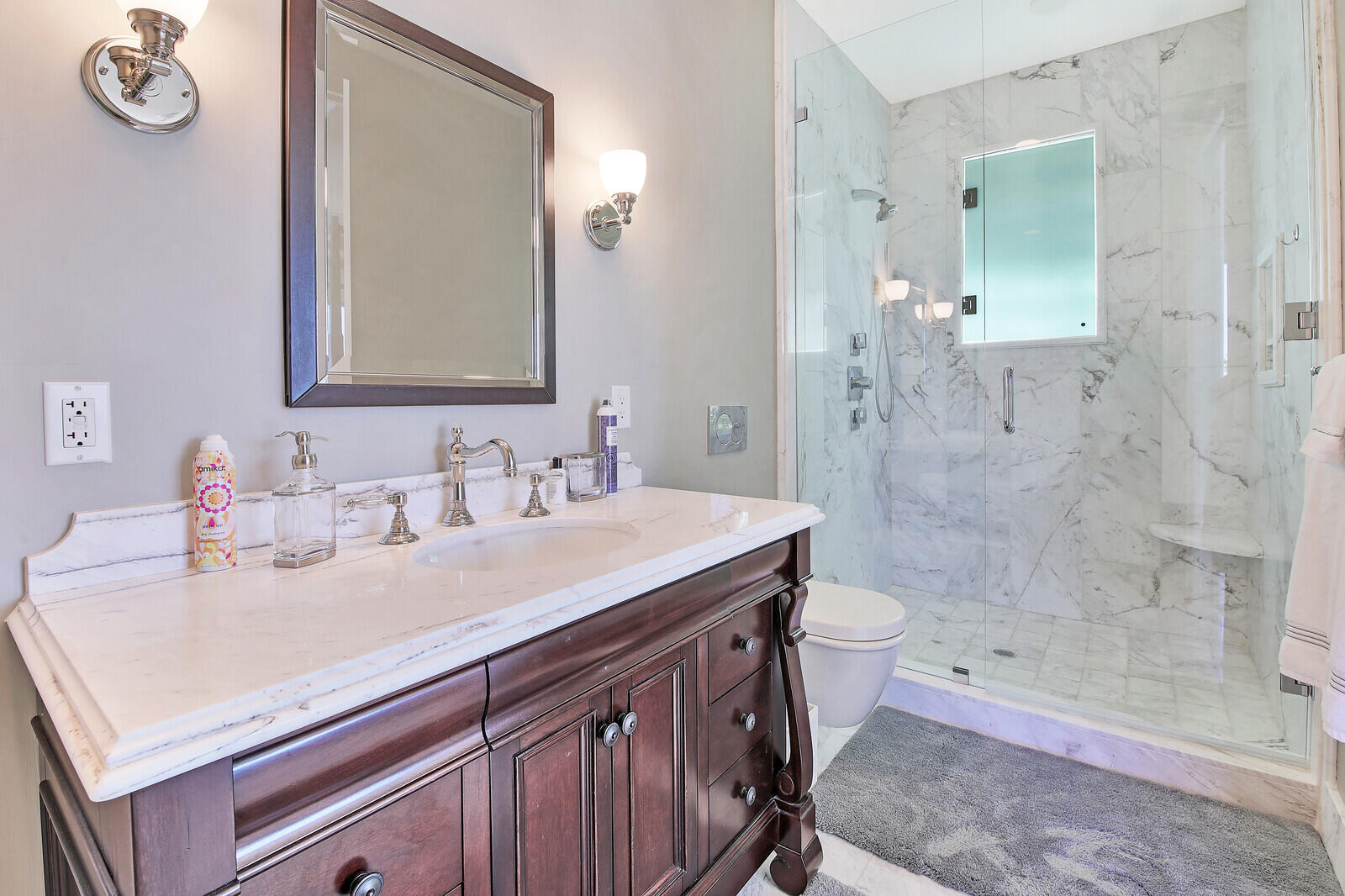 3370 Bridgegate Drive Jupiter, FL 33477 - Photo 33 of 55 a bathroom with a sink a toilet a mirror and shower