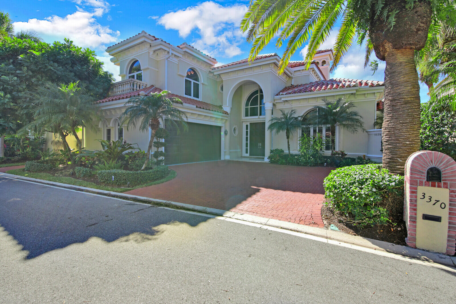 3370 Bridgegate Drive Jupiter, FL 33477 - Photo 4 of 55 a front view of a house with garden