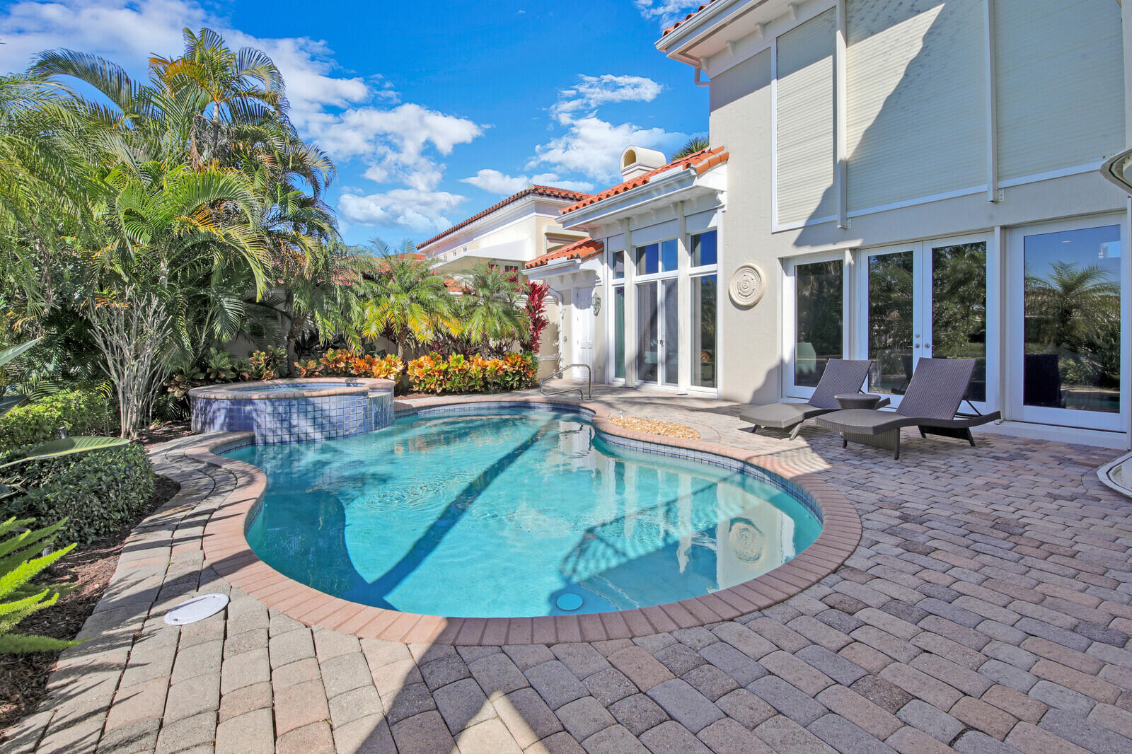 3370 Bridgegate Drive Jupiter, FL 33477 - Photo 42 of 55 a view of a swimming pool with lounge chair