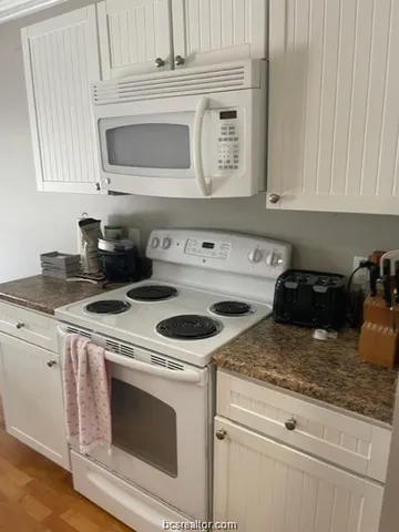 a kitchen with cabinets a sink and a refrigerator