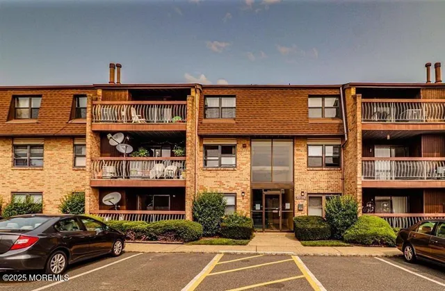 a car parked in front of a big building