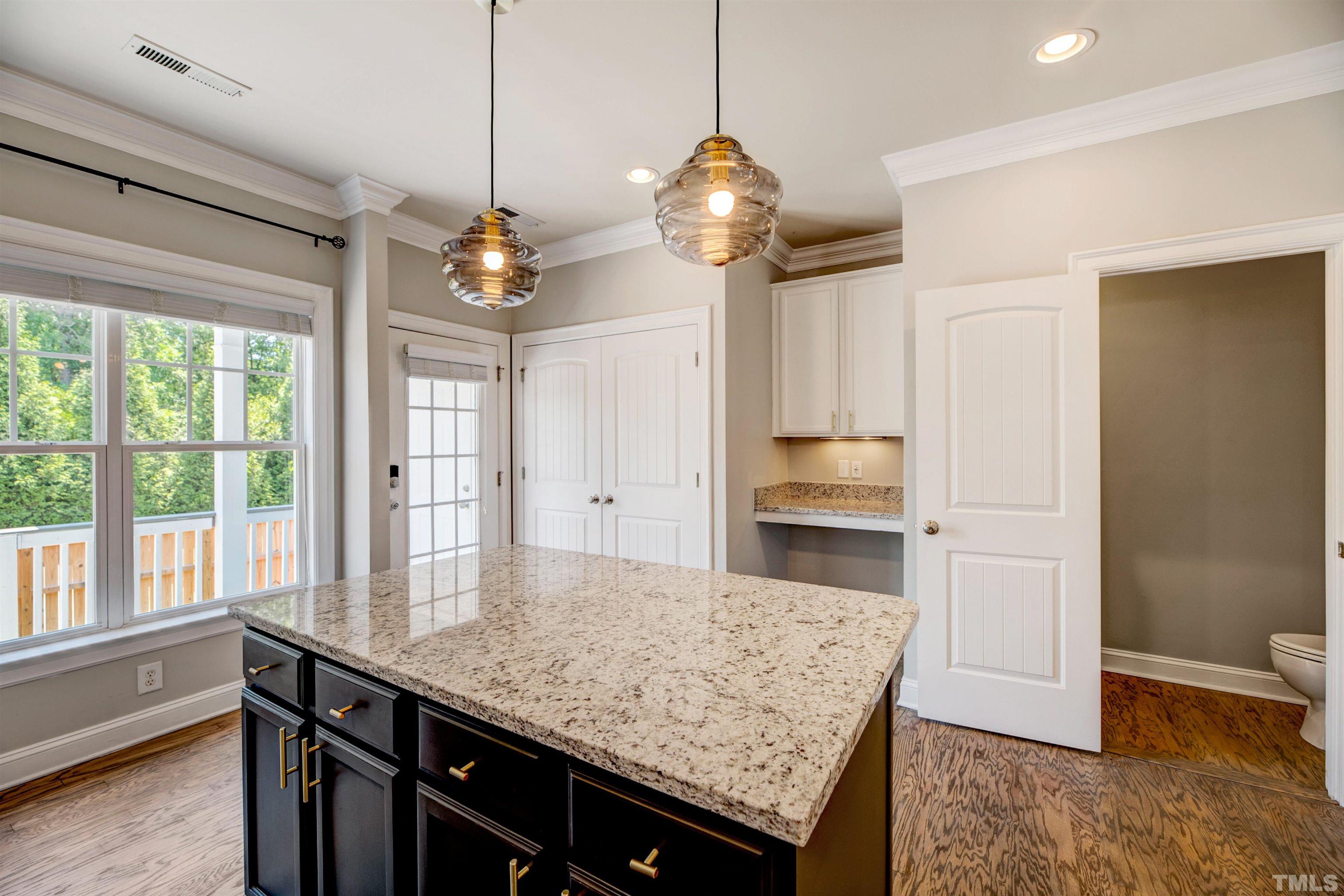 7736 ACC Boulevard Raleigh, NC 27617 - Photo 14 of 37 a kitchen with a table and chandelier