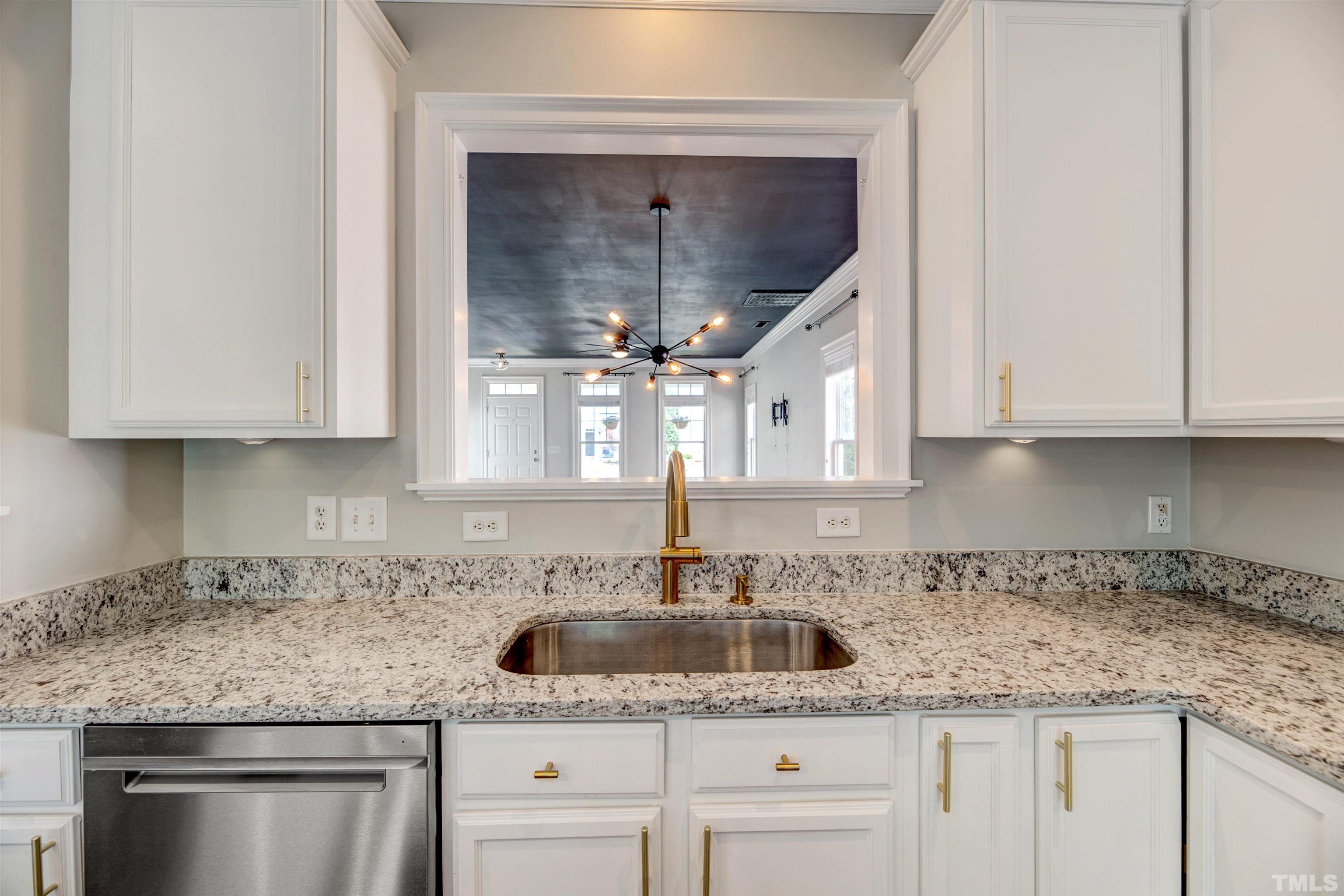 7736 ACC Boulevard Raleigh, NC 27617 - Photo 15 of 37 a kitchen with granite countertop a sink and cabinets