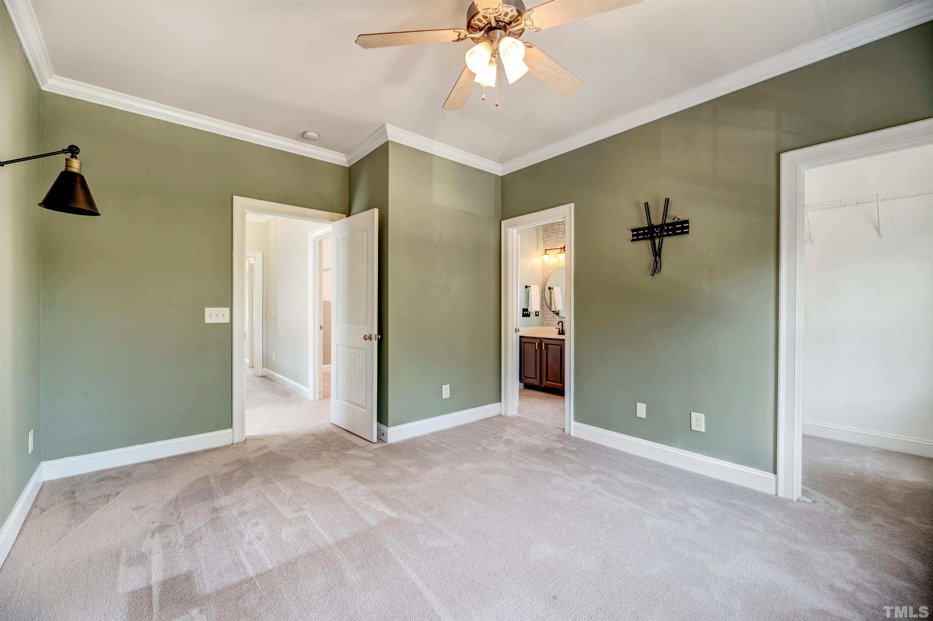 7736 ACC Boulevard Raleigh, NC 27617 - Photo 18 of 37 a view of a room with a chandelier fan and closet