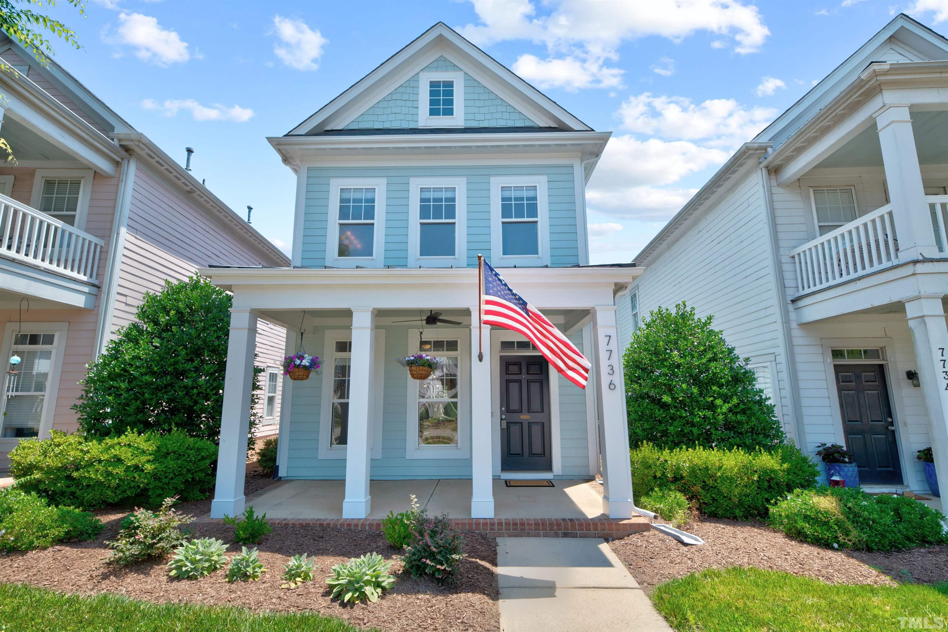 7736 ACC Boulevard Raleigh, NC 27617 - Photo 2 of 37 a front view of a house with garden