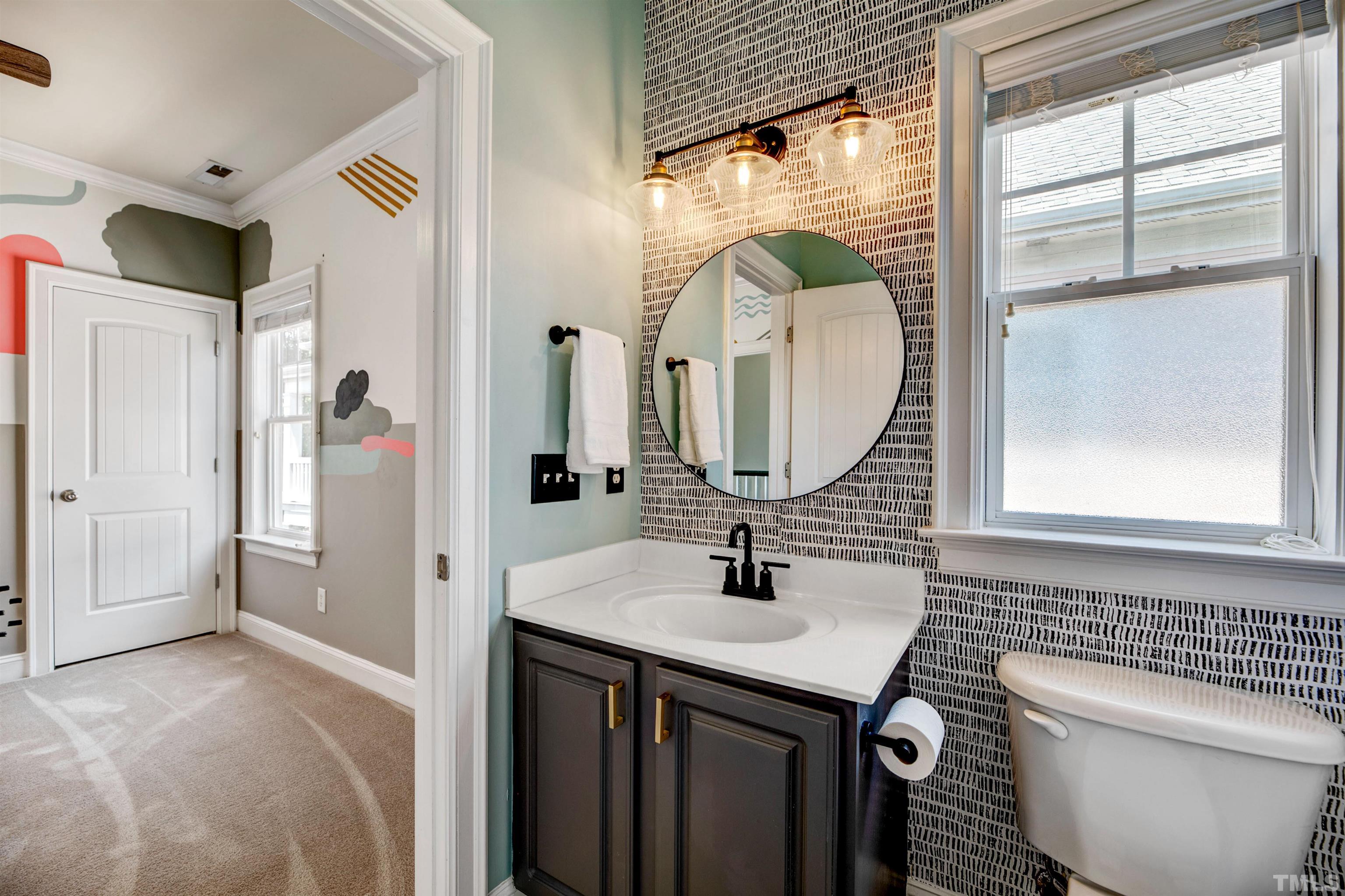 7736 ACC Boulevard Raleigh, NC 27617 - Photo 21 of 37 a bathroom with a sink and a mirror