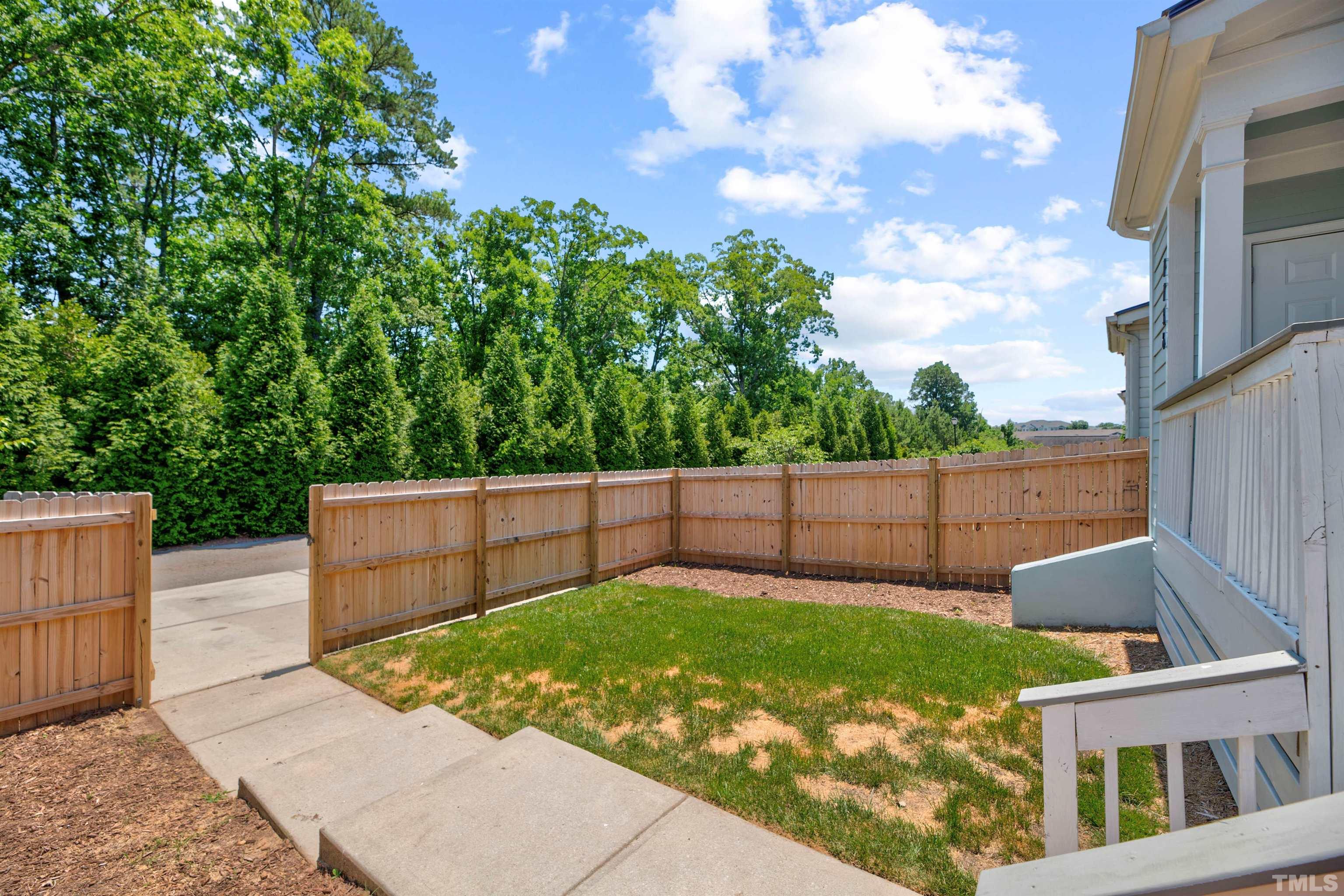 7736 ACC Boulevard Raleigh, NC 27617 - Photo 35 of 37 a view of a backyard with a large tree