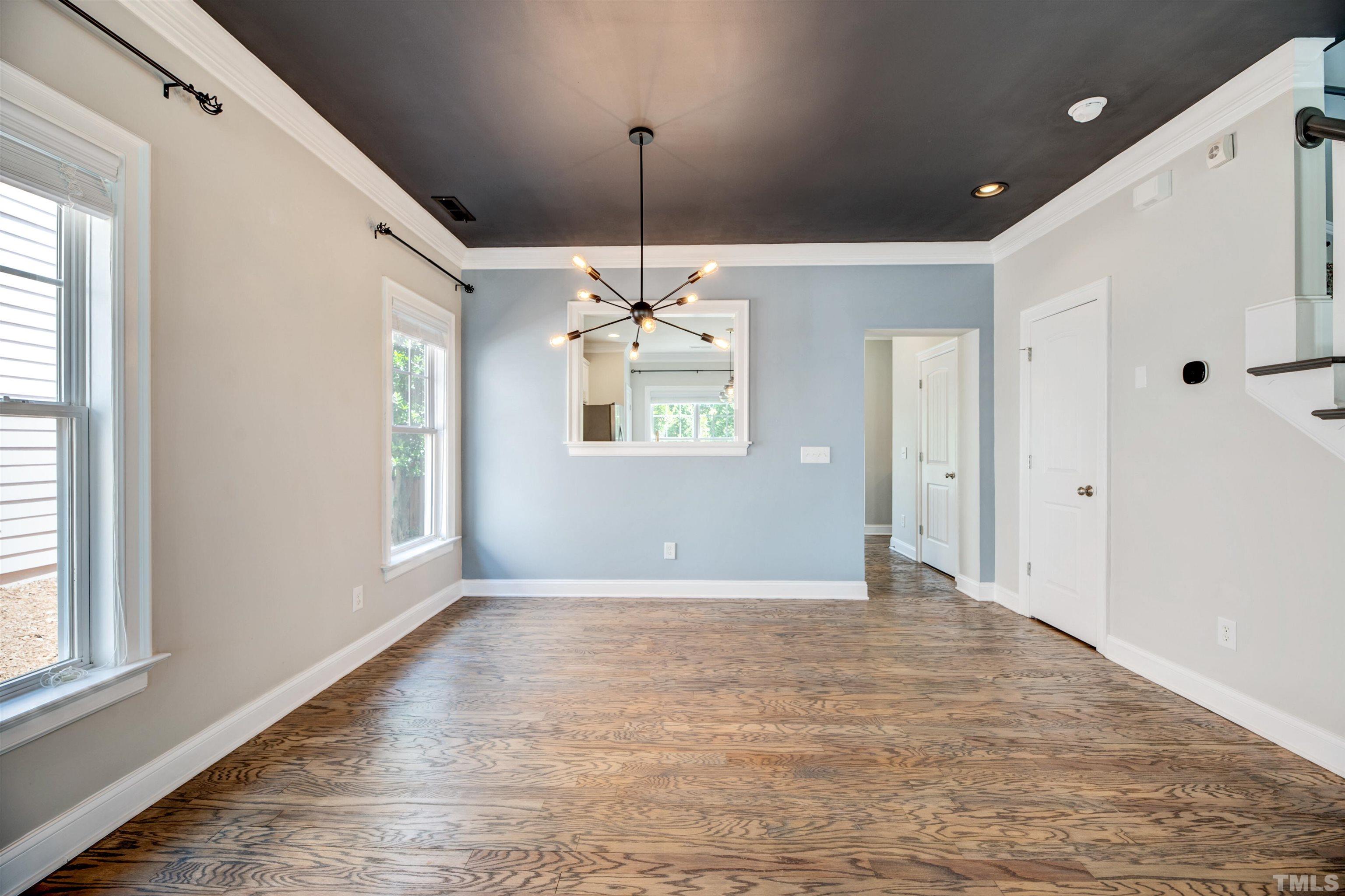 7736 ACC Boulevard Raleigh, NC 27617 - Photo 8 of 37 a view of a livingroom with a chandelier fan and windows