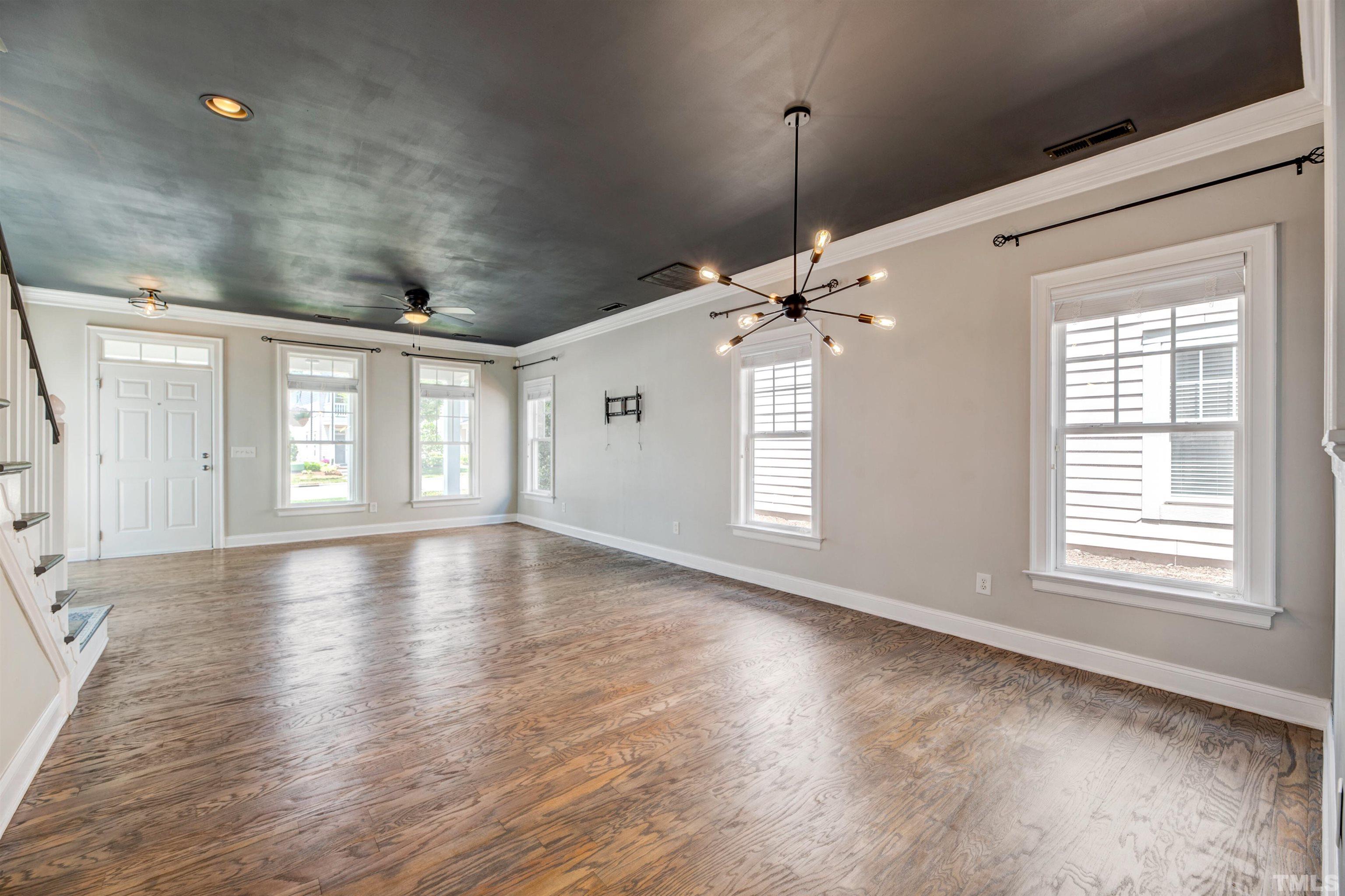 7736 ACC Boulevard Raleigh, NC 27617 - Photo 9 of 37 a view of livingroom with window hardwood floor and ceiling window
