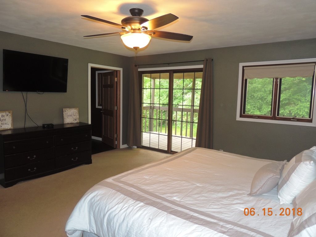 12294 County Line Road Roscoe, IL 61073 - Photo 14 of 25 a bedroom with a bed and a flat screen tv