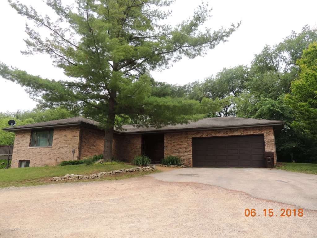 12294 County Line Road Roscoe, IL 61073 - Photo 3 of 25 a front view of a house with a garden