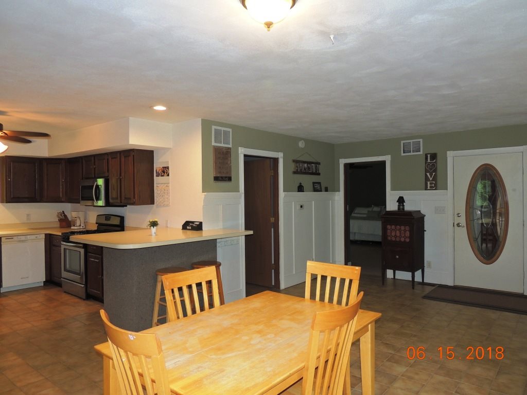 12294 County Line Road Roscoe, IL 61073 - Photo 7 of 25 a kitchen with a refrigerator and a table