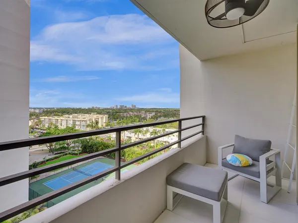 a view of a chairs and table in a balcony