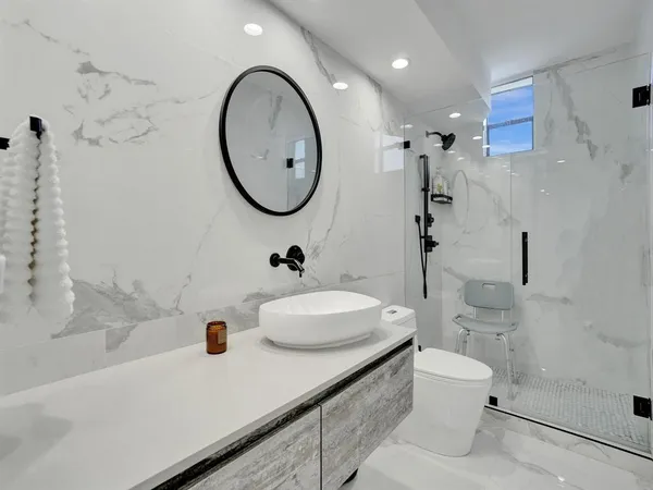 a bathroom with a sink a toilet and a shower