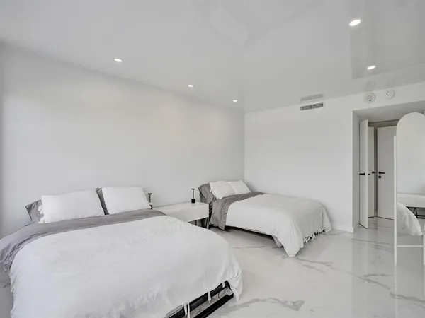 a bedroom with two beds and a walk in closet