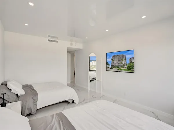 a bedroom with a bed and a painting on the wall