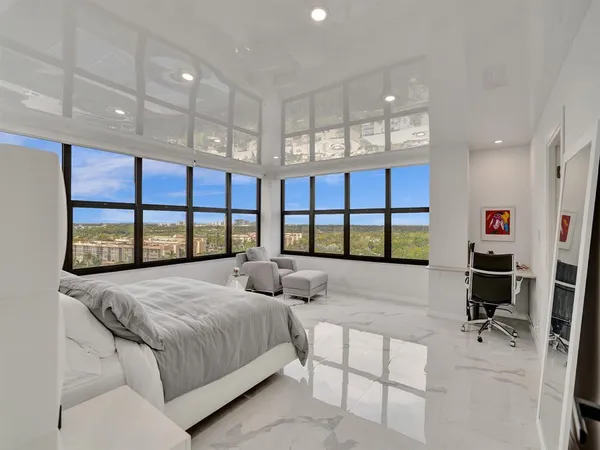 a bedroom with a bed and a large window