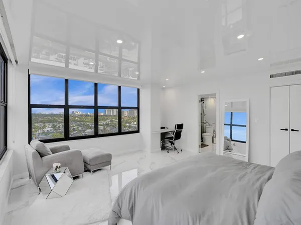 a bed room with a bed and a large window