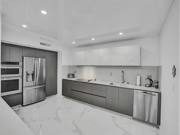 a kitchen with a sink stainless steel appliances and cabinets