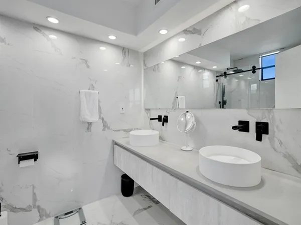 a bathroom with a granite countertop sink a toilet and a mirror
