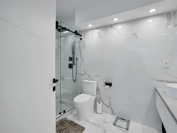 a bathroom with a toilet and a shower