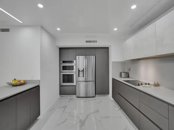 a kitchen with stainless steel appliances granite countertop refrigerator sink and stove