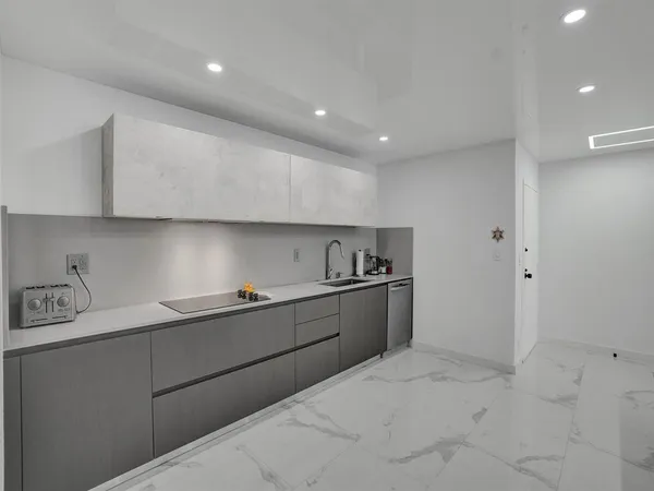 a kitchen with granite countertop a sink and cabinets