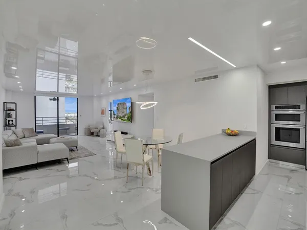 a view of kitchen with furniture and refrigerator