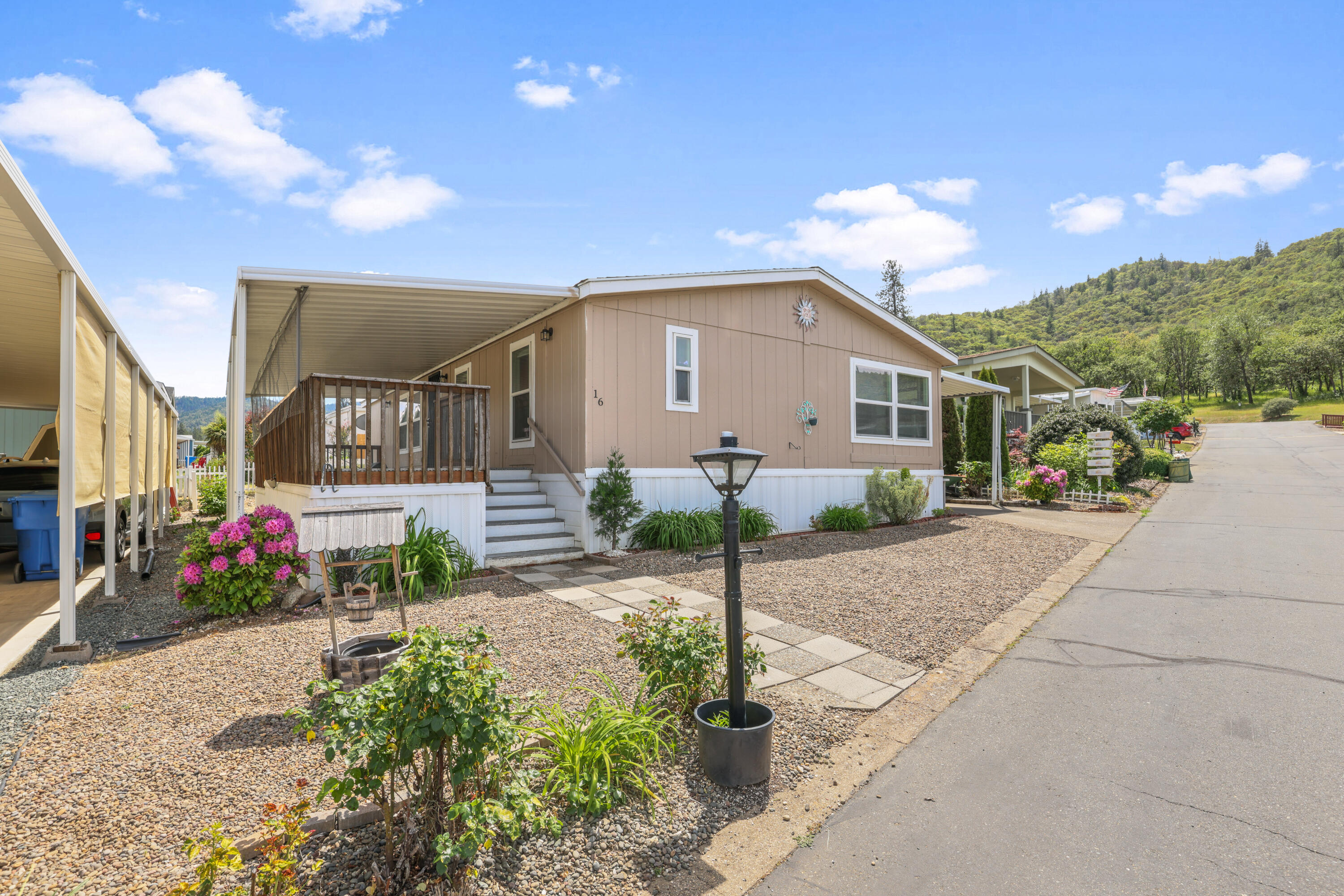8401 Old Stage Road, Unit 16 Central Point, OR 97502 - Photo 2 of 23 a front view of a house with a yard and potted plants
