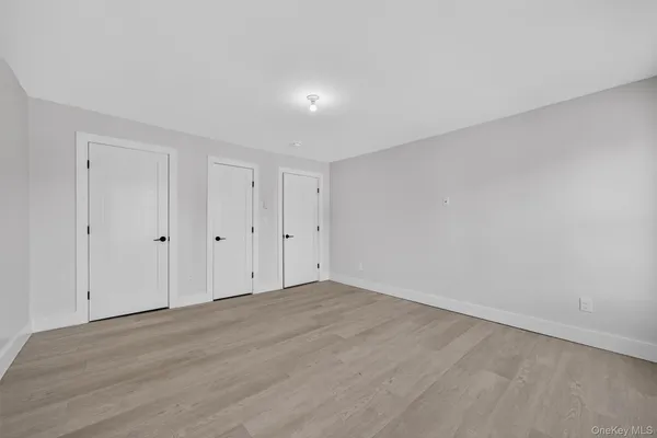 a kitchen with granite countertop a refrigerator and a stove top oven