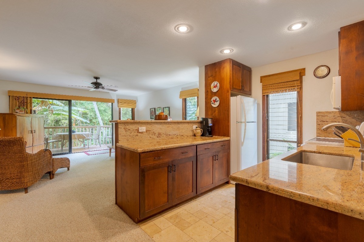 a kitchen with stainless steel appliances granite countertop a sink and a stove