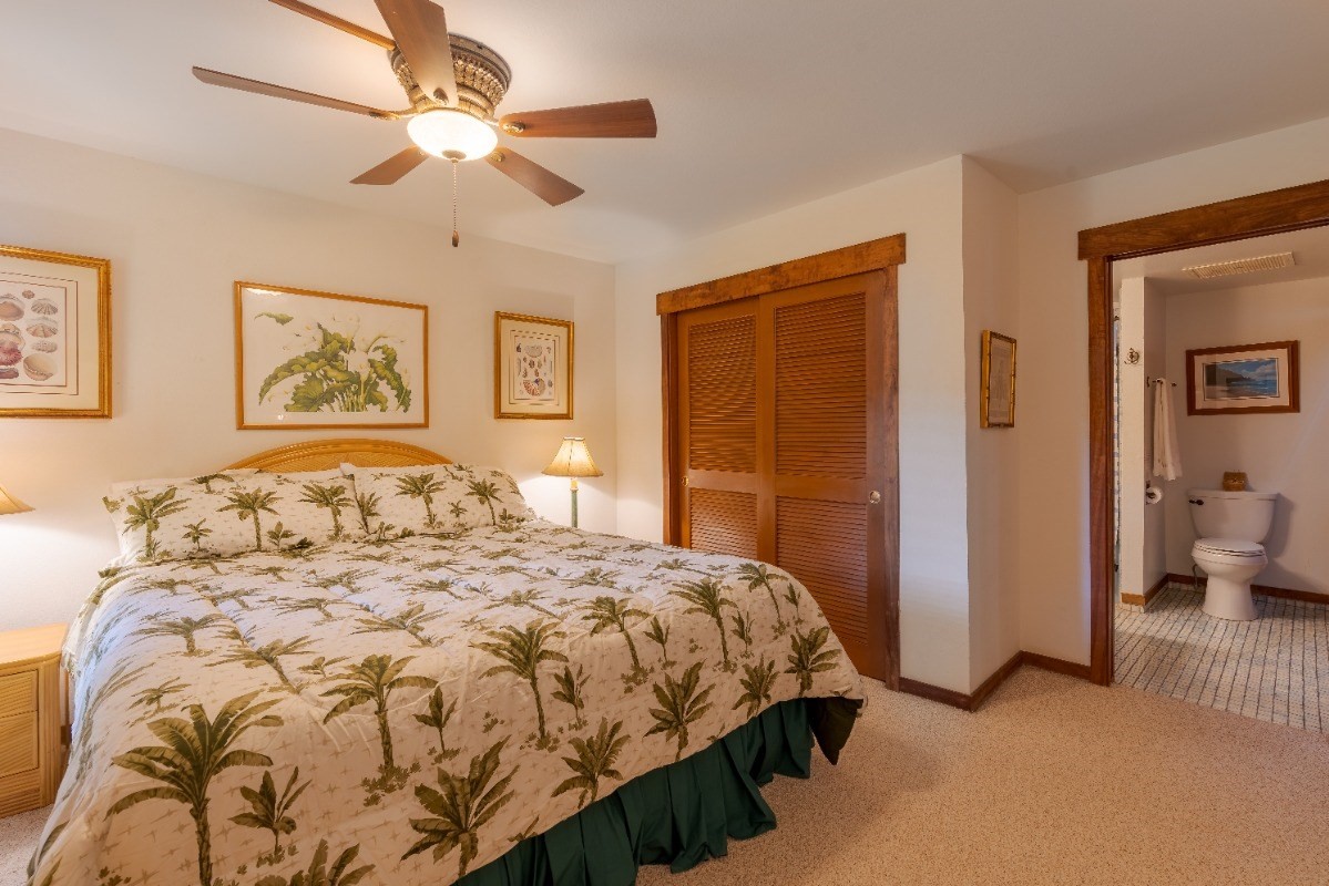 2721 Poipu Road, Unit 420 Koloa, HI 96756 - Photo 11 of 26 a bedroom with a large bed and a chandelier
