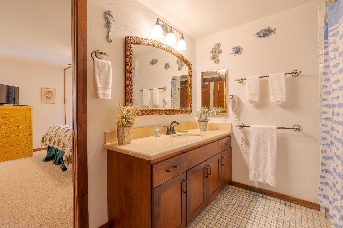 2721 Poipu Road, Unit 420 Koloa, HI 96756 - Photo 13 of 26 a bathroom with a sink a mirror and a shower