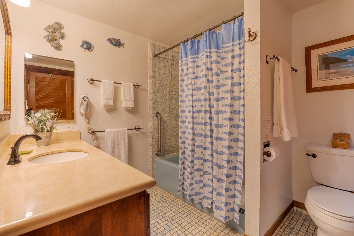 2721 Poipu Road, Unit 420 Koloa, HI 96756 - Photo 14 of 26 a bathroom with a sink toilet and shower