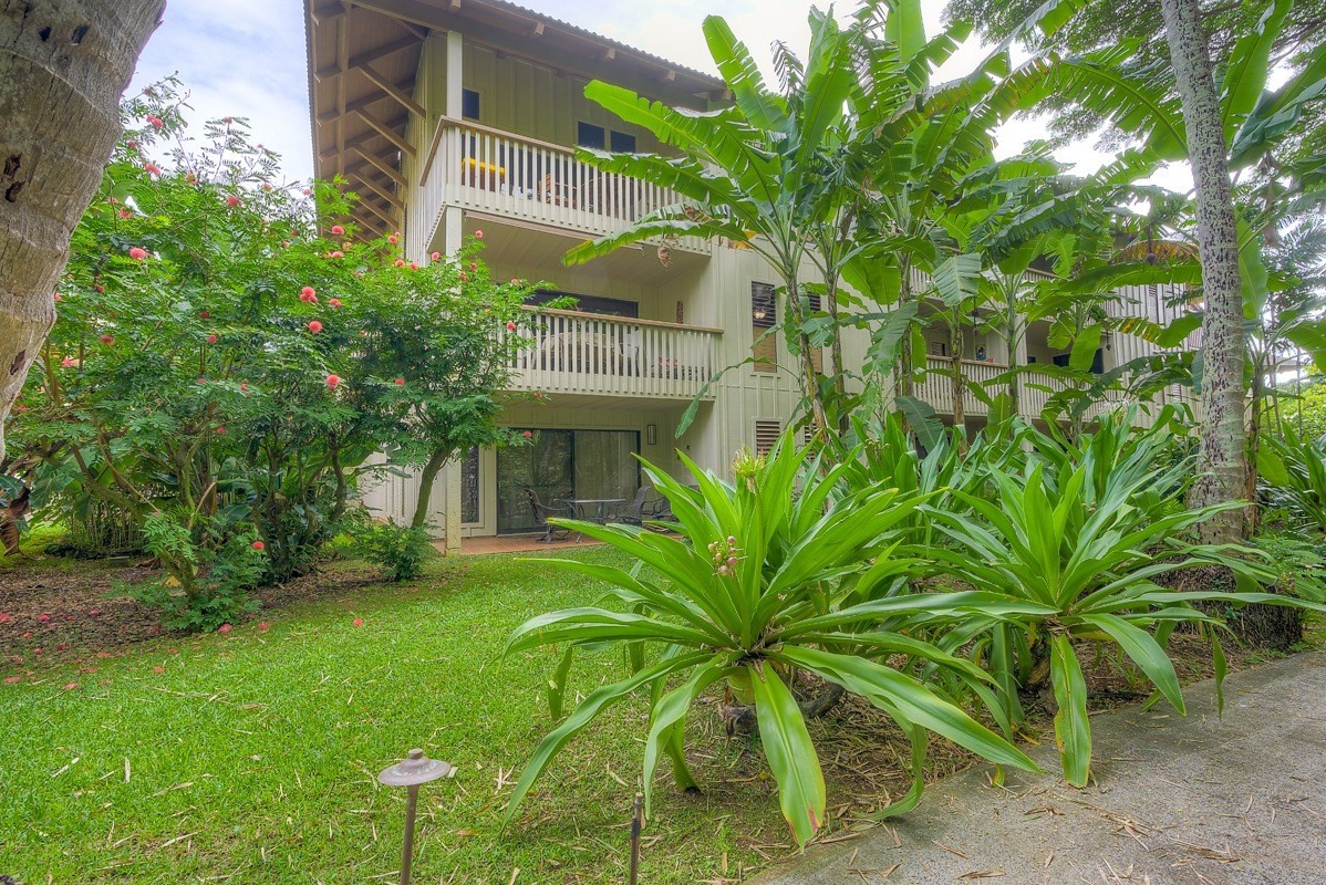 2721 Poipu Road, Unit 420 Koloa, HI 96756 - Photo 17 of 26 a view of a white house with a big yard and potted plants