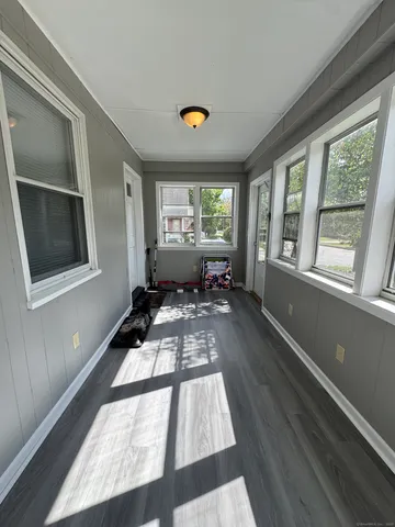 a living room with a couch and a floor to ceiling window