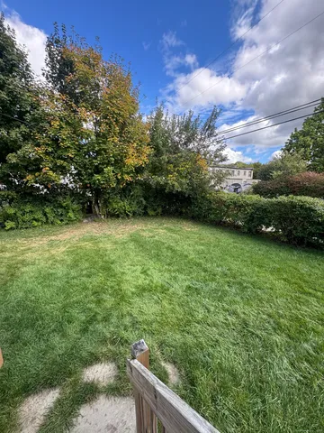 a view of a yard with an outdoor seating and deck