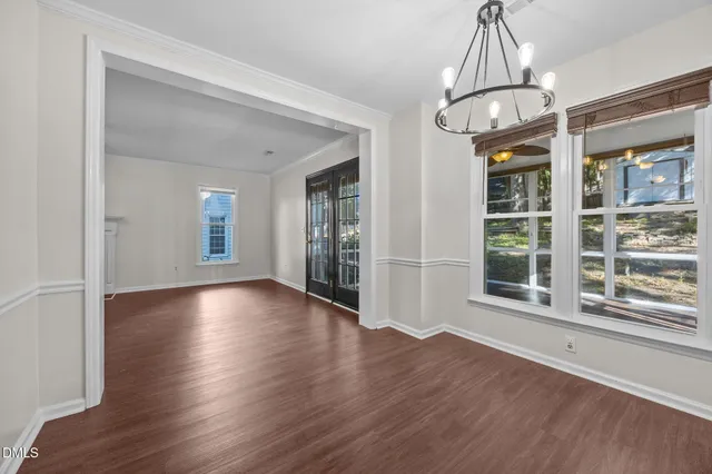 a kitchen with granite countertop wooden floors and white stainless steel appliances