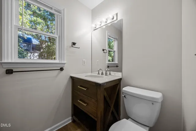 a view of empty room with wooden floor and ceiling fan