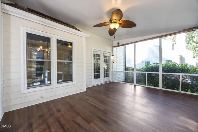 a view of empty room with wooden floor
