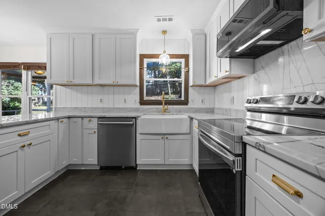 a kitchen with cabinets stainless steel appliances and sink