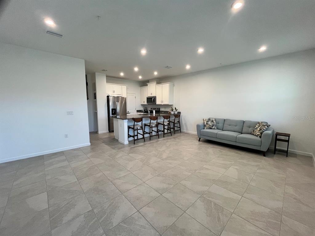 4208 Sadler Road Apopka, FL 32712 - Photo 6 of 7 a living room with furniture and a kitchen view