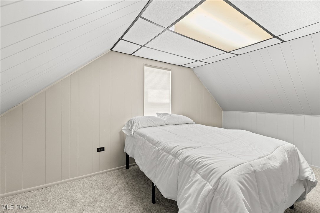 430 Stanley Road Akron, OH 44312 - Photo 23 of 36 Carpeted bedroom with lofted ceiling and wood walls
