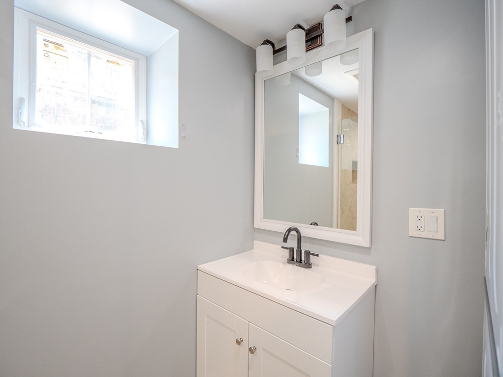 159 Mishawum Road Woburn, MA 01801 - Photo 26 of 41 a bathroom with a sink and a mirror